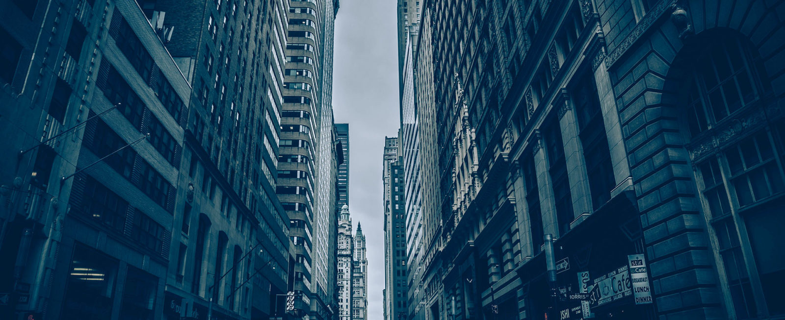 A view of some tall buildings from the ground.